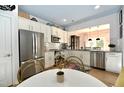 Modern kitchen boasts stainless steel appliances, white cabinetry, and stylish countertops with adjacent eat in area at 8613 Thunderwood Dr, Raleigh, NC 27617