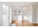 Bright laundry room with white washer and dryer, access to a deck through glass doors at 113 Belgium Pl, Zebulon, NC 27597