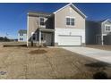New two-story home with attached garage, fresh lawn and neutral-toned siding, set in a modern neighborhood at 1137 Centerview Dr, Nashville, NC 27856