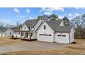 Beautiful two-story home boasts a three car garage and a charming front porch at 120 Lane Farms Way Way, Holly Springs, NC 27540