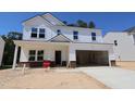 New construction two-story home with a large garage, white siding and brick foundation at 1233 Dimaggio Dr # 7, Raleigh, NC 27616