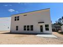 Back exterior view of new construction two-story home with white siding and minimal landscaping at 1233 Dimaggio Dr # 7, Raleigh, NC 27616