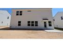 Rear exterior view of new construction two-story home with white siding and minimal landscaping at 1233 Dimaggio Dr # 7, Raleigh, NC 27616
