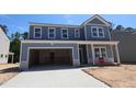 Beautiful two-story home with a large garage and light blue siding at 1240 Dimaggio Dr # 35, Raleigh, NC 27616