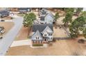 Aerial view of home in a neighborhood with manicured backyard and mature trees at 18 Orangewood Court Ct, Lillington, NC 27546