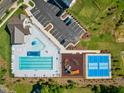 Aerial view of a pool, playground, tennis court, parking and green space at 21 Nimble Way # 176, Clayton, NC 27520