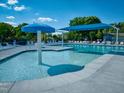 View of zero entry community pool featuring mushroom water feature, covered sitting, and lounge chairs at 21 Nimble Way # 176, Clayton, NC 27520