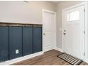 The entryway features updated flooring, stylish wainscoting, and a modern black and white aesthetic at 2218 Christian Light Rd, Fuquay Varina, NC 27526
