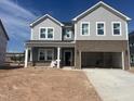 Two-story home featuring gray siding, brick accents, white trim, and an attached two-car garage with an unfinished front yard at 249 Tidal Pool Way, Cary, NC 27519