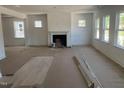 Open-concept living room featuring a fireplace, recessed lighting, and plenty of natural light at 253 Tidal Pool Way, Cary, NC 27519