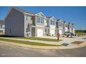 New townhomes with individual garages, landscaping, and sidewalks create an inviting community at 309 Cherry Laurel Dr, Sanford, NC 27332