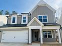 Charming two-story home with a brick-lined garage, gray siding, and a covered front porch at 3287 Roundly Rd # 13, New Hill, NC 27562