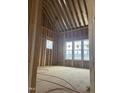 New construction bedroom featuring a vaulted ceiling and large windows overlooking the property's backyard at 395 Meadow Walk Dr, Fuquay Varina, NC 27526
