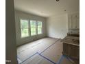 Bright dining room space features a large window overlooking lush greenery, new construction at 395 Meadow Walk Dr, Fuquay Varina, NC 27526