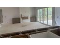 Bright living room with fireplace, gray cabinets, and sliding glass doors to deck at 395 Meadow Walk Dr, Fuquay Varina, NC 27526