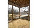 Spacious screened-in porch with wood floors and scenic lake view; ready for relaxing and entertaining at 395 Meadow Walk Dr, Fuquay Varina, NC 27526