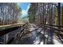 Long driveway lined with wooden fencing through wooded acreage at 4100 Durham Rd, Raleigh, NC 27614