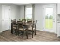 Dining area with a wooden table, seating for six, and a view of the backyard at 417 Tormore Dr, Sanford, NC 27330