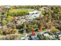 Aerial view of the home with a park and recreation area nearby, surrounded by mature trees at 518 Worth St, Raleigh, NC 27601