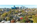 Aerial view of a neighborhood with the home indicated, set against a cityscape backdrop at 518 Worth St, Raleigh, NC 27601
