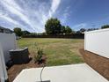 Expansive backyard with a well-maintained lawn, privacy fence, and a concrete patio area at 6132 Arsenal Ave, Raleigh, NC 27610
