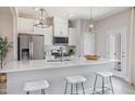 Bright kitchen featuring stainless steel appliances, a quartz countertop island, and stylish pendant lighting at 6132 Arsenal Ave, Raleigh, NC 27610