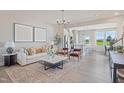 Inviting living room adjacent to kitchen features luxury vinyl flooring and plenty of natural light at 6134 Arsenal Ave, Raleigh, NC 27610