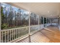 Relaxing covered porch with ample space and a peaceful view of the surrounding landscape at 69 Holly Tree Dr, Timberlake, NC 27583