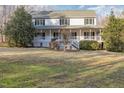 A beautiful two-story home with a covered front porch, perfect for enjoying the outdoors at 69 Holly Tree Dr, Timberlake, NC 27583