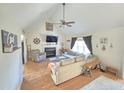 Cozy living room with fireplace, fan, and ample seating at 7098 Blue Springs St, Gibsonville, NC 27249