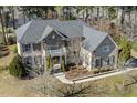 Aerial view of a traditional two-story home with a gray roof, manicured lawn, and mature trees at 1013 Timber Mist Ct, Cary, NC 27519