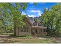 Charming cabin-style home with a cozy front porch nestled among the trees at 1031 Wait Ave, Wake Forest, NC 27587