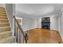 Inviting living room with hardwood floors and a classic black fireplace at 1031 Wait Ave, Wake Forest, NC 27587