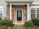 Inviting front door with stone pillars and manicured bushes create a warm welcome to this lovely home at 11425 Shadow Elms Ln, Raleigh, NC 27614