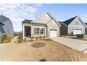 Attractive single Gathering home with stone accents, an attached garage, and manicured landscaping at 1255 White Flint Cir, Durham, NC 27703
