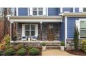 Inviting front porch features stone accents, seating, and a decorative front door at 130 Willow Bend Dr, Youngsville, NC 27596