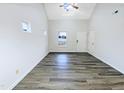 Spacious living room with vaulted ceiling, wood-look flooring, and ample natural light at 1628 Beacon Village Dr, Raleigh, NC 27604