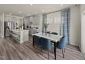 Stylish dining area featuring a dining table with seating and decor, adjacent to an open-concept kitchen at 1775 Pie Filling Dr, Haw River, NC 27258