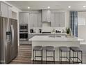 Modern kitchen featuring stainless steel appliances, white countertops, and a convenient island with barstool seating at 1775 Pie Filling Dr, Haw River, NC 27258
