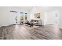 Bright living room boasts vaulted ceilings, vinyl floors, modern decor, and natural light from large windows at 1915 Lambert Rd, Graham, NC 27253