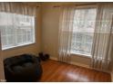 This bedroom includes two windows, hardwood floors, and a comfortable beanbag chair at 2000 University Woods Rd # 201, Raleigh, NC 27603
