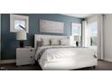 Calm bedroom with a white bed, blue walls, modern lamps, and bright windows at 257 Beacon Dr, Pittsboro, NC 27312