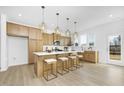 Bright, modern kitchen with a large island, quartz countertop, and stainless steel appliances at 27 Silver Moon Ln # 114, Clayton, NC 27527