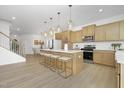 Spacious kitchen with a large island, pendant lighting, stainless appliances, and breakfast bar seating at 27 Silver Moon Ln # 114, Clayton, NC 27527