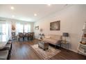 Open living space featuring modern furniture and decor, with wood floors and large windows providing ample natural light at 306 Brier Summit Pl, Durham, NC 27703