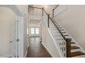 Bright foyer with hardwood floors, staircase, and paneled doors at 326 Umstead St, Sanford, NC 27330
