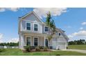 Stylish home with a manicured lawn, gray siding, and a welcoming covered porch at 326 Umstead St, Sanford, NC 27330
