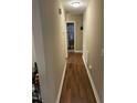 Hallway with hardwood floors, neutral walls and view into a bedroom at 421 Angus Pl, Stem, NC 27581
