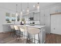 Bright open kitchen featuring gray cabinetry, a large central island, and modern pendant lighting fixtures at 43 Mable Court # 4, Lillington, NC 27546