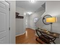 Inviting foyer with hardwood floors, stylish console table, and a coat rack for added convenience at 532 Smithridge Way, Fuquay Varina, NC 27526